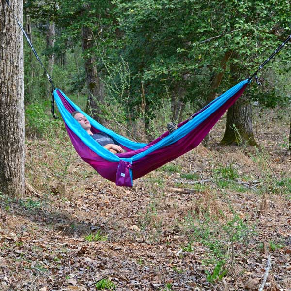 Bright Purple and Blue GO2 Traveler Nylon Hammock with Women Relaxing in Woods