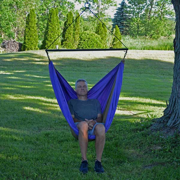 Man Sitting in Purple GO2 Traveler Portable Camping Chair Outside